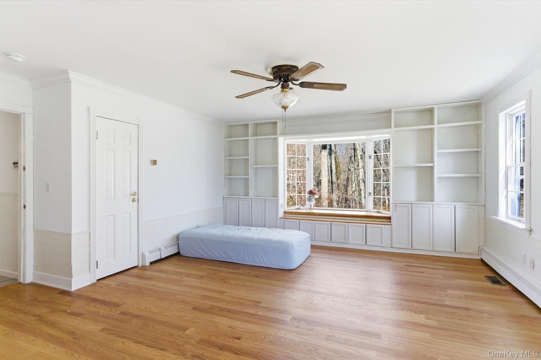 45 Eastwood Road Miller Place, NY 11764 - Photo 8 of 45 a spacious bedroom with a large bed and a large window