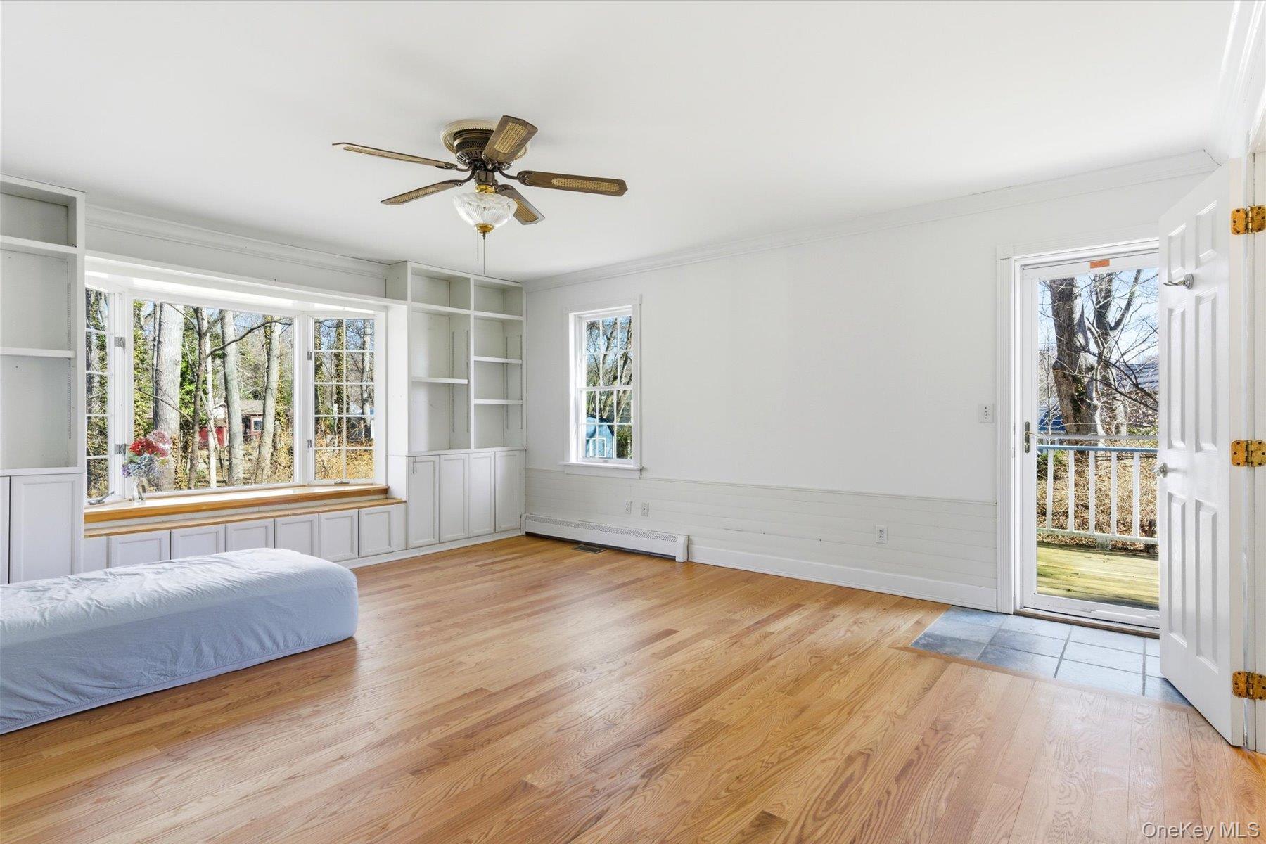 45 Eastwood Road Miller Place, NY 11764 - Photo 9 of 45 a view of an empty room with a window and wooden floor