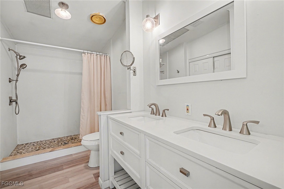 5228 Stringfellow Road St. James City, FL 33956 - Photo 15 of 35 a bathroom with a sink and a mirror