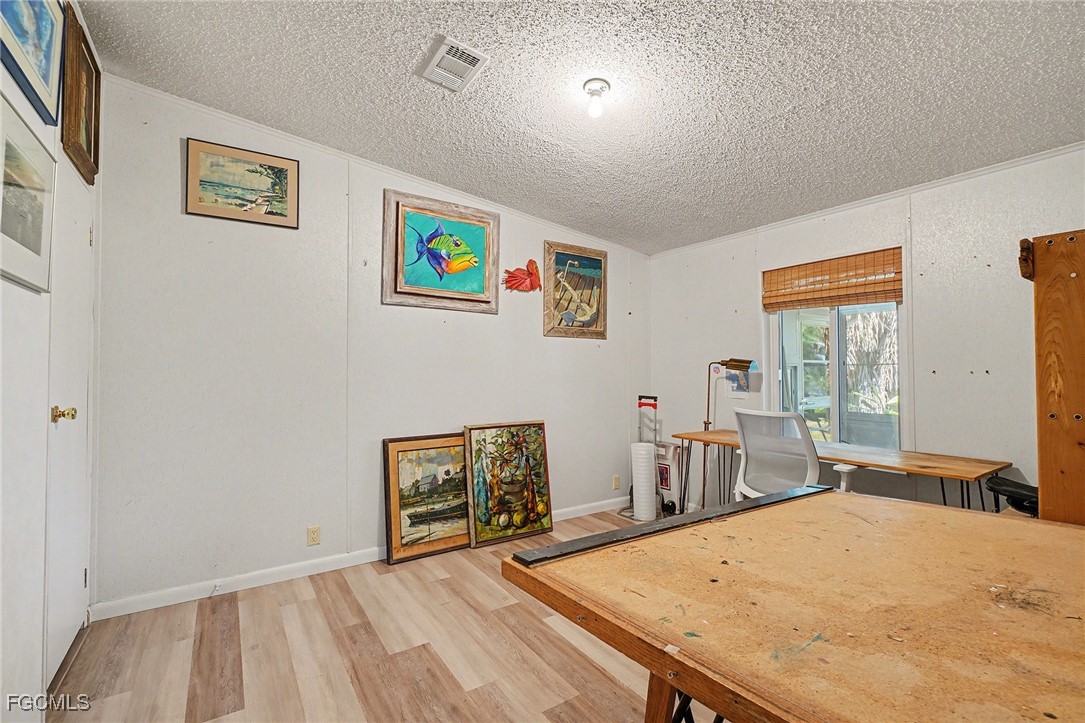 5228 Stringfellow Road St. James City, FL 33956 - Photo 16 of 35 a bedroom with a bed and furniture