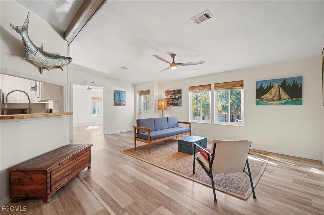 5228 Stringfellow Road St. James City, FL 33956 - Photo 2 of 35 a living room with furniture a fireplace and a table