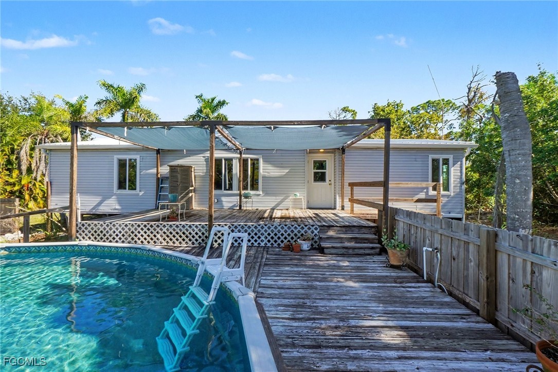 5228 Stringfellow Road St. James City, FL 33956 - Photo 23 of 35 a front view of house with deck and furniture