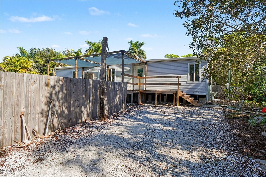 5228 Stringfellow Road St. James City, FL 33956 - Photo 26 of 35 a view of a house with a backyard and a tree