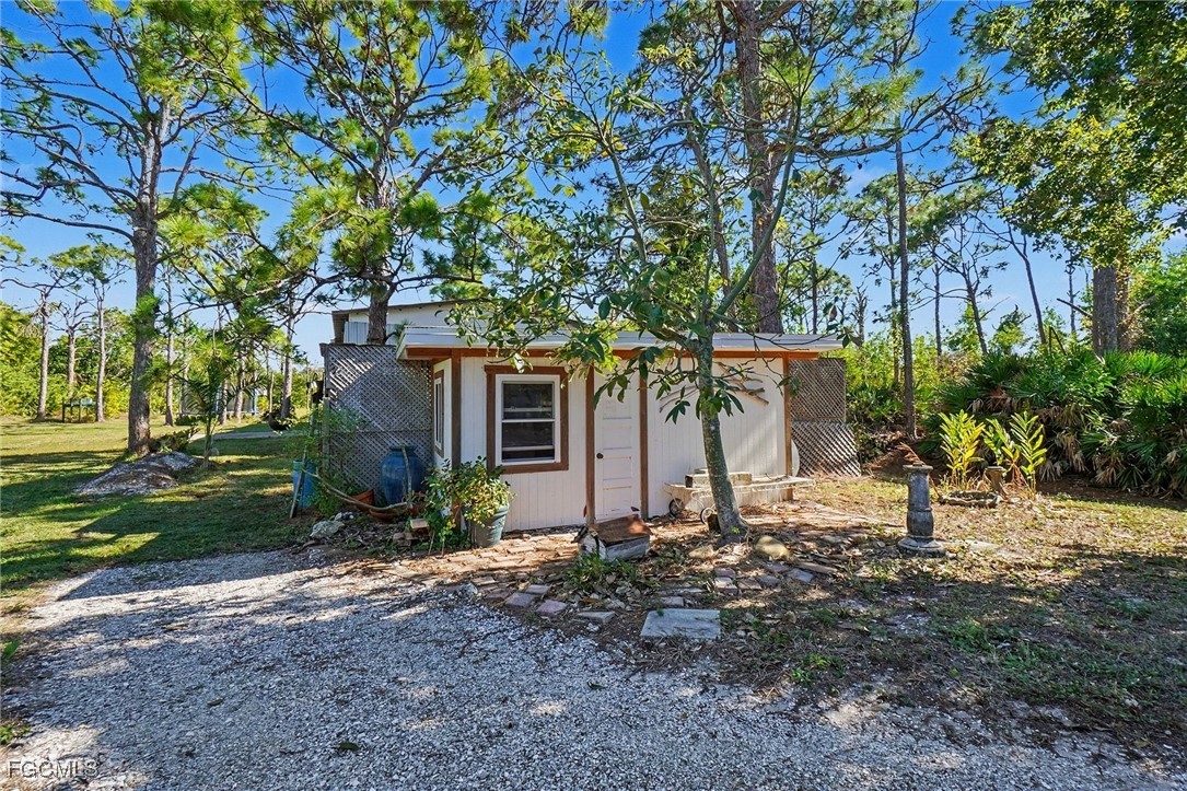 5228 Stringfellow Road St. James City, FL 33956 - Photo 27 of 35 a view of a house with a tree in the yard