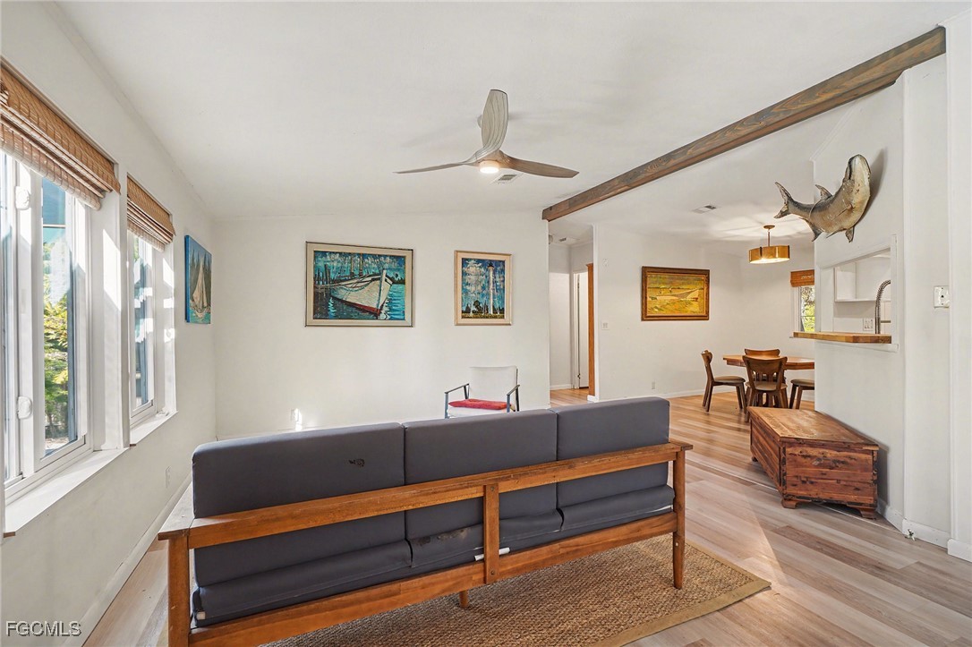 5228 Stringfellow Road St. James City, FL 33956 - Photo 5 of 35 a living room with furniture and wooden floor