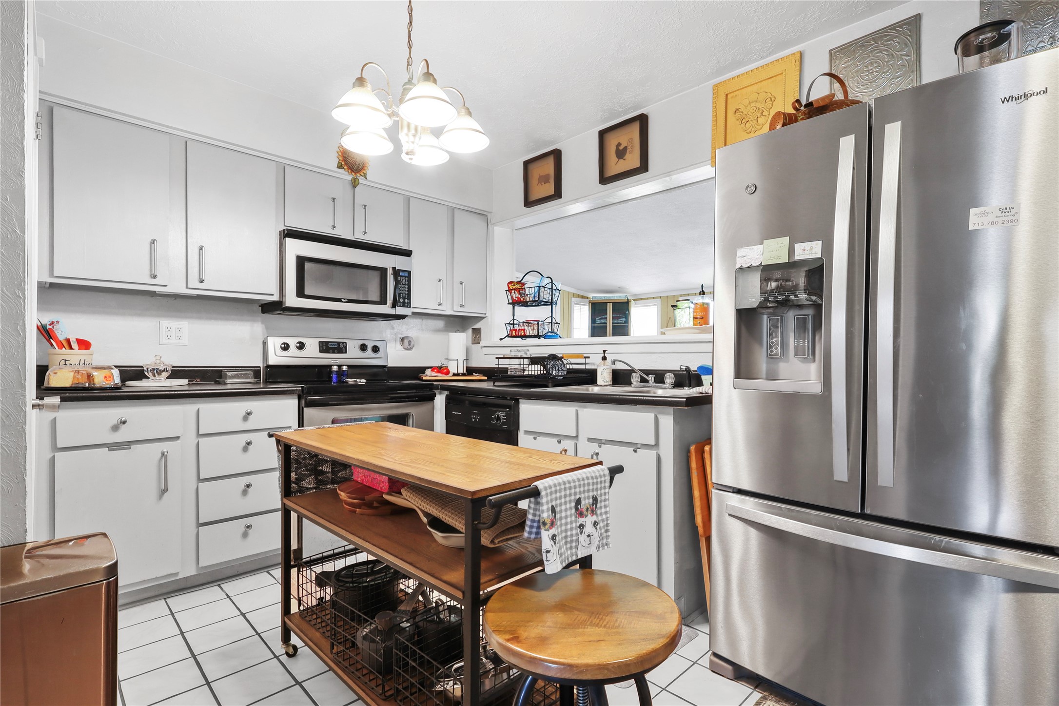 a kitchen with stainless steel appliances a refrigerator stove microwave and sink