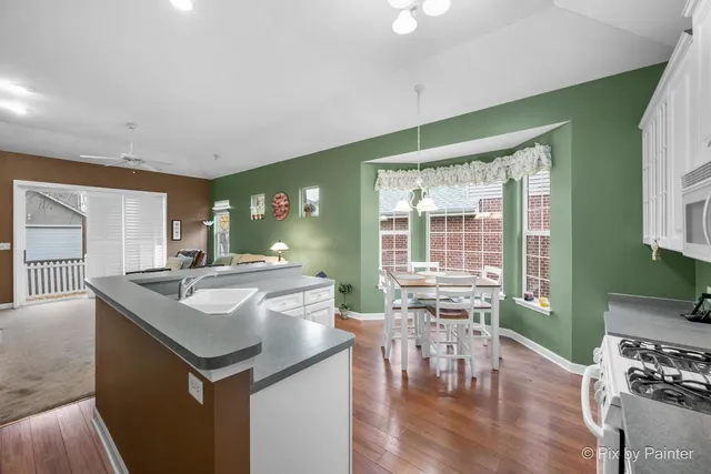 a kitchen with stainless steel appliances granite countertop a sink and a stove