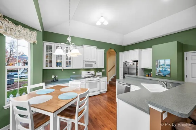a large kitchen with a table and chairs