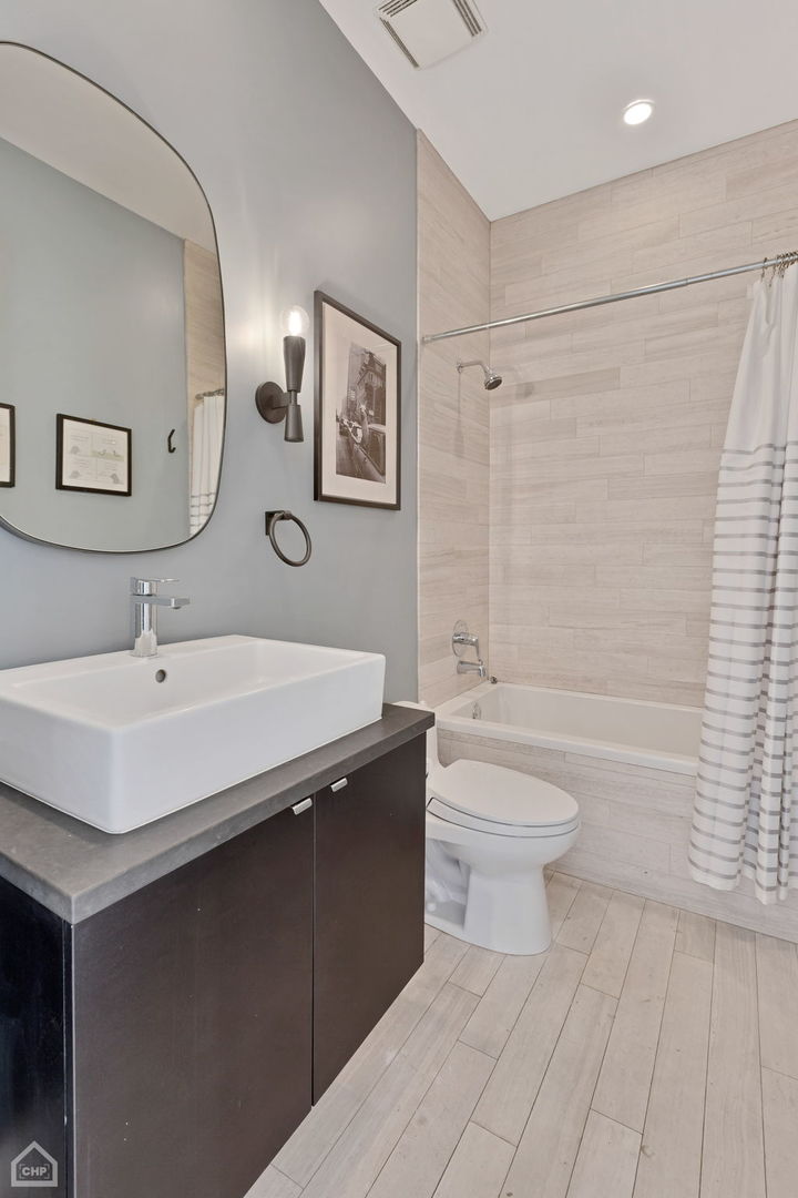 155 North Aberdeen Street, Unit 304 Chicago, IL 60607 - Photo 19 of 33 a bathroom with a sink a toilet and shower