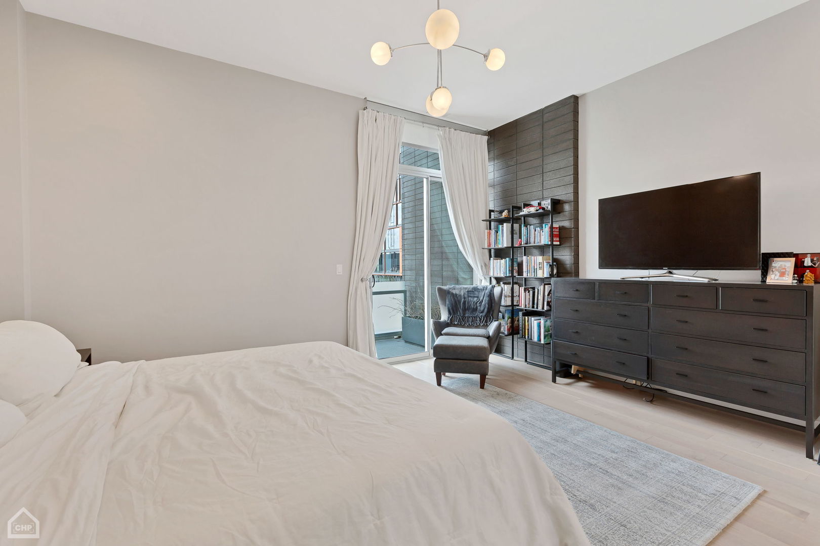 155 North Aberdeen Street, Unit 304 Chicago, IL 60607 - Photo 24 of 33 a bedroom with a bed and flat screen tv