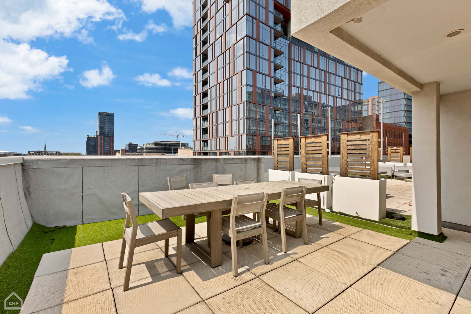 155 North Aberdeen Street, Unit 304 Chicago, IL 60607 - Photo 30 of 33 a patio with a table and chairs