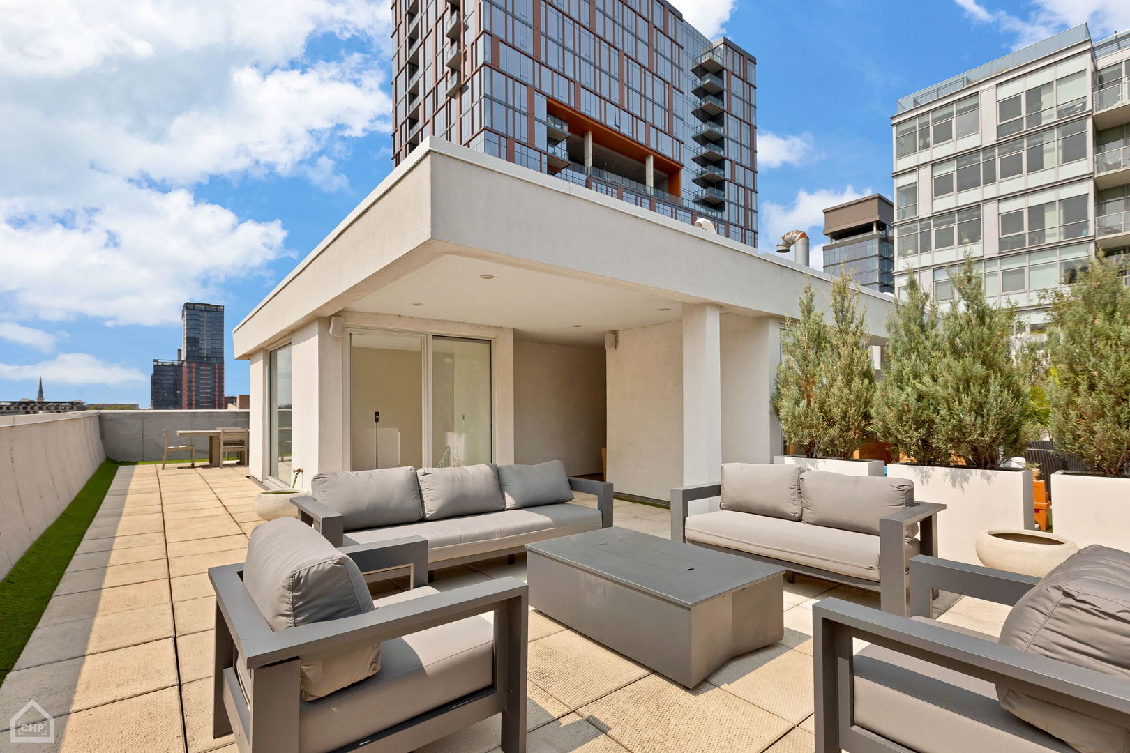 155 North Aberdeen Street, Unit 304 Chicago, IL 60607 - Photo 32 of 33 a view of a patio with couches and a potted plant on a table