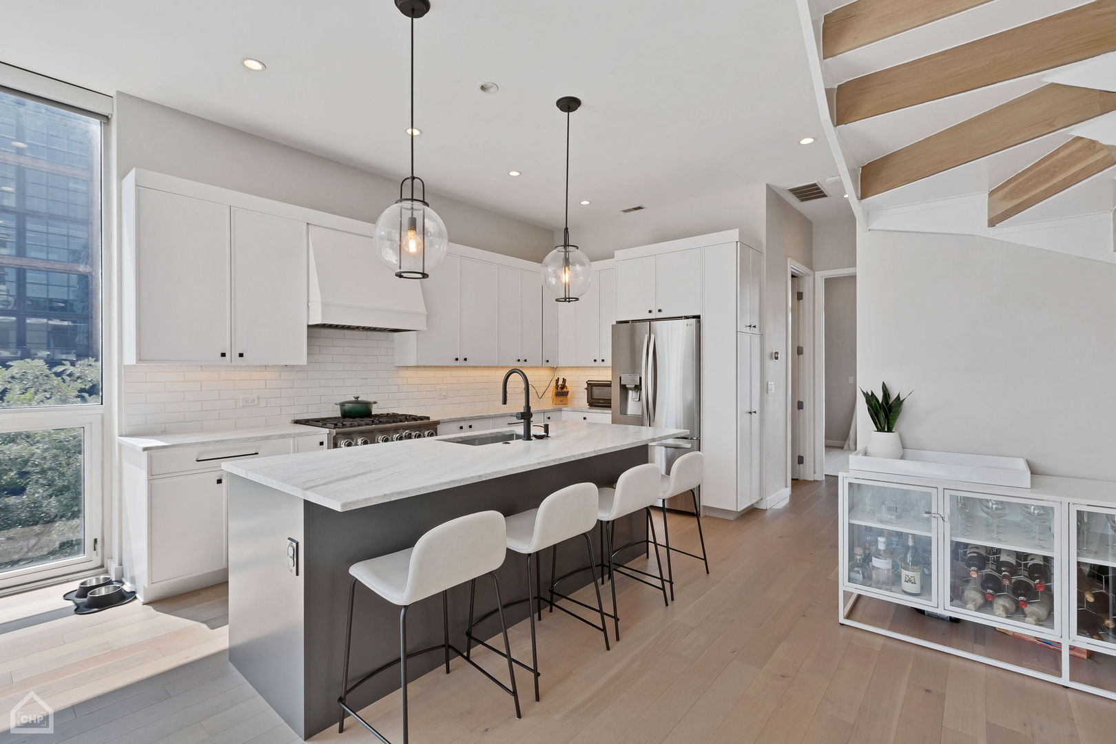 155 North Aberdeen Street, Unit 304 Chicago, IL 60607 - Photo 8 of 33 a kitchen with stainless steel appliances granite countertop a sink a stove a refrigerator and island with wooden floor