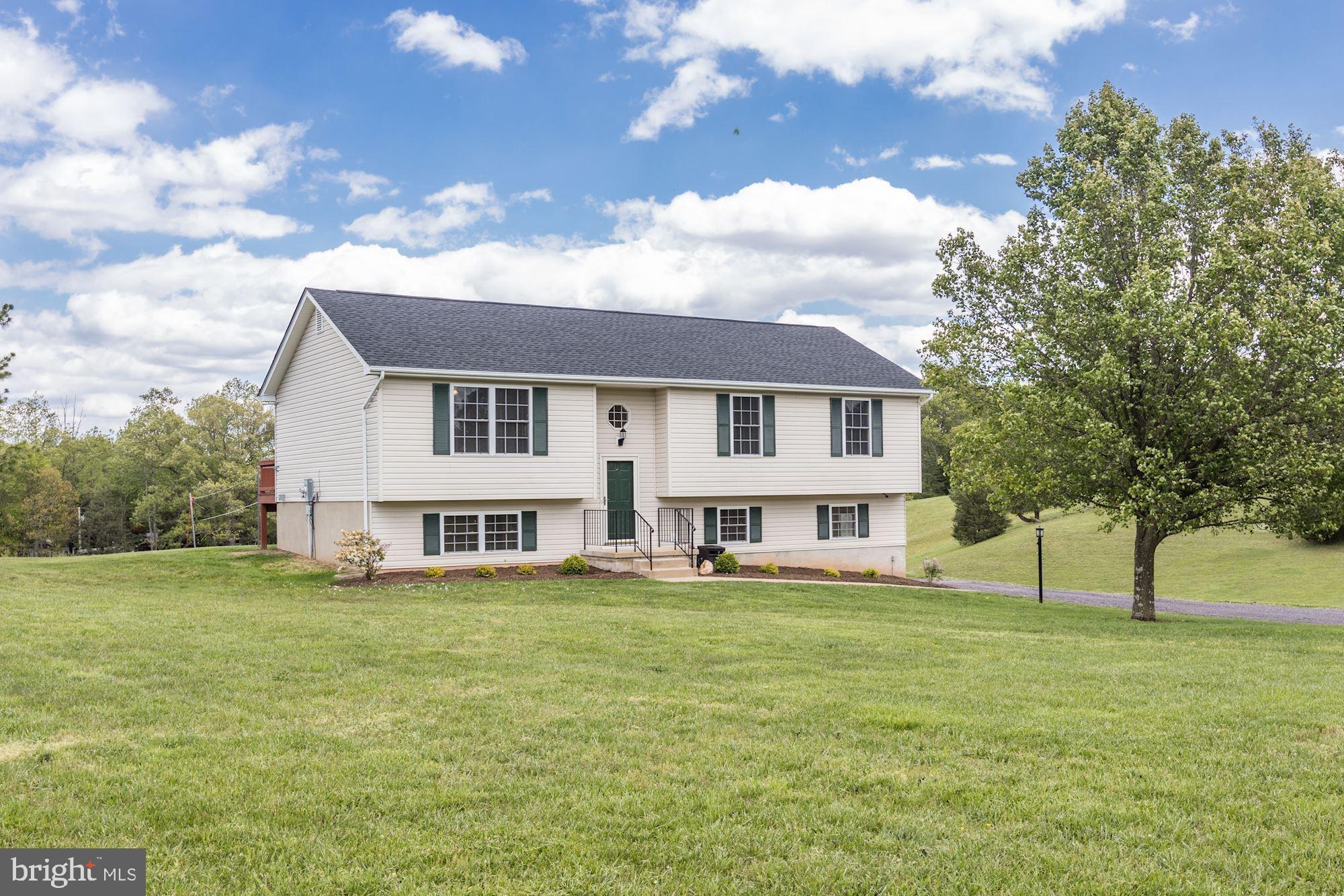 14065 Micah Road Rixeyville, VA 22737 - Photo 2 of 40 a view of a house with a big yard and a large tree