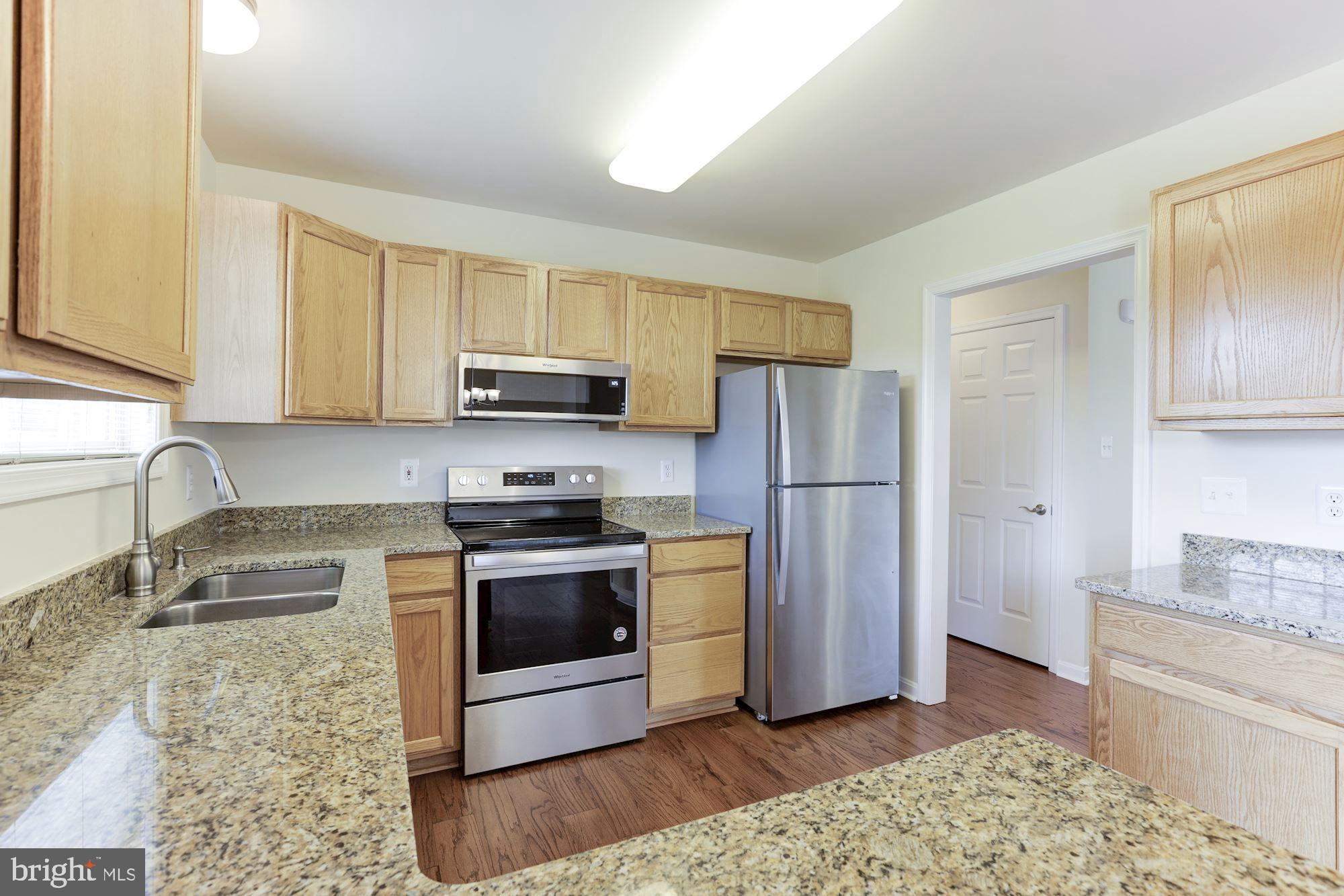 14065 Micah Road Rixeyville, VA 22737 - Photo 12 of 40 a kitchen with stainless steel appliances granite countertop a refrigerator stove and sink