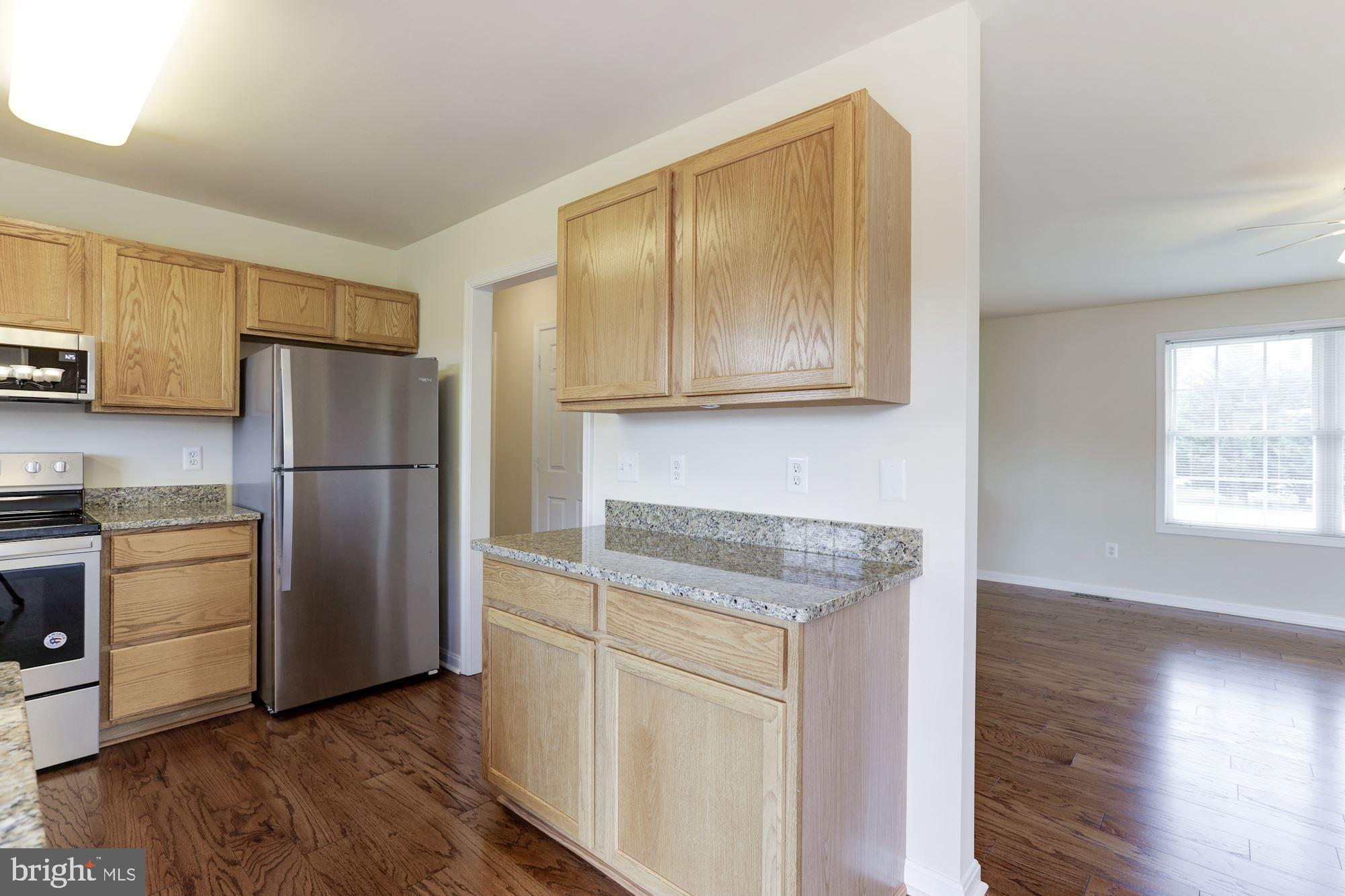 14065 Micah Road Rixeyville, VA 22737 - Photo 13 of 40 a kitchen with wooden cabinets and stainless steel appliances