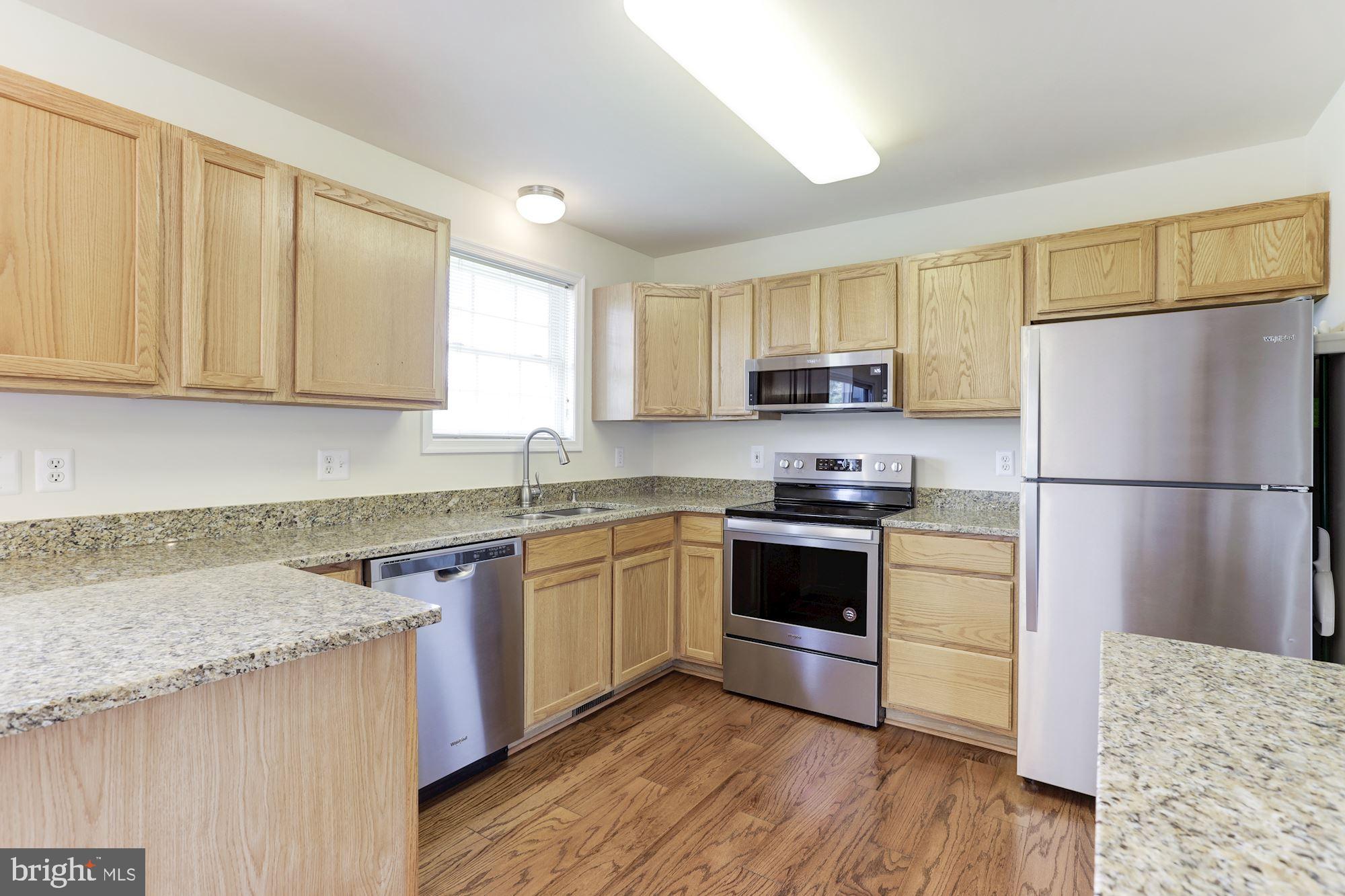 14065 Micah Road Rixeyville, VA 22737 - Photo 14 of 40 a kitchen with granite countertop a refrigerator stove top oven and sink