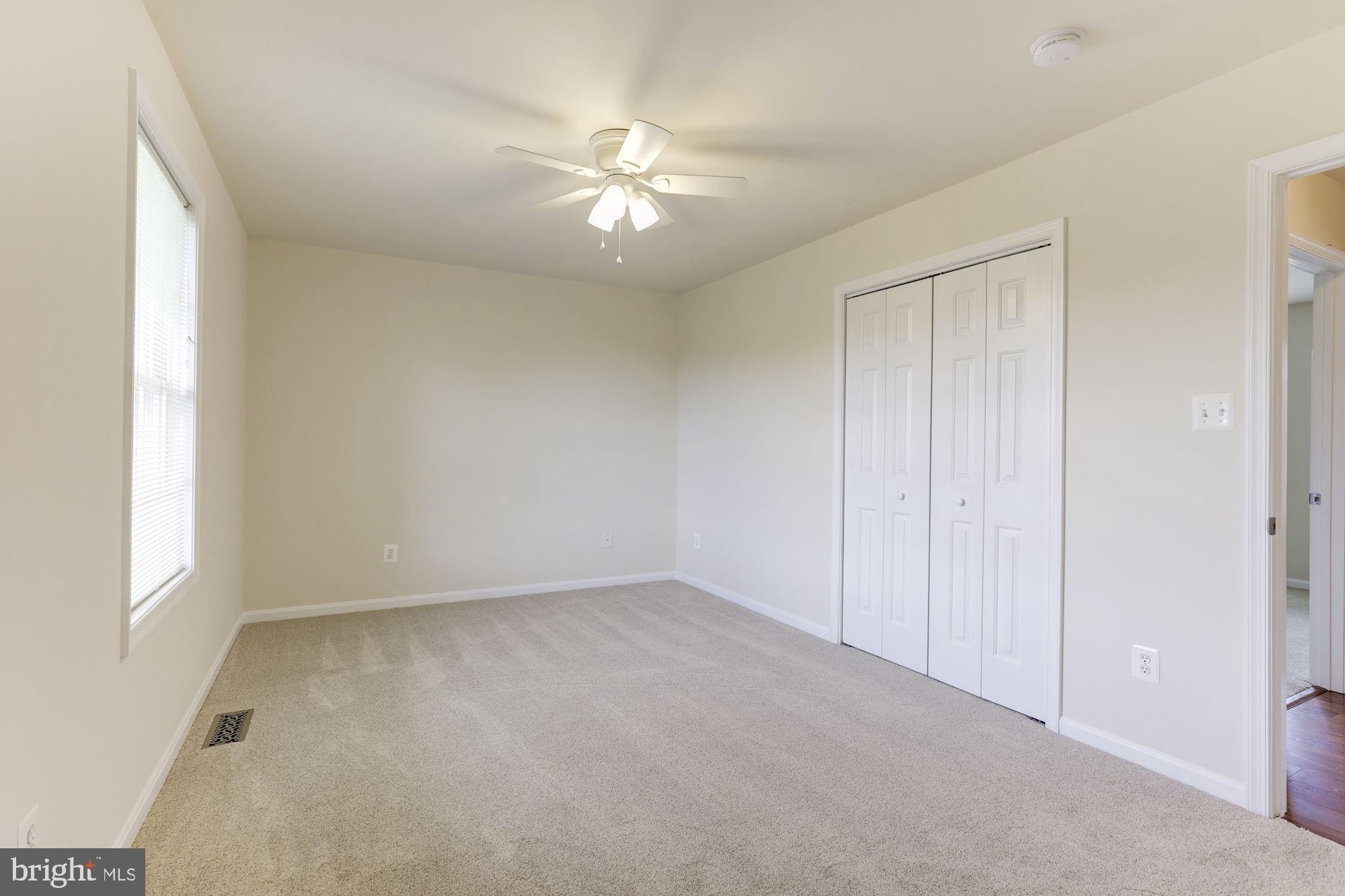 14065 Micah Road Rixeyville, VA 22737 - Photo 17 of 40 an empty room with chandelier fan and windows