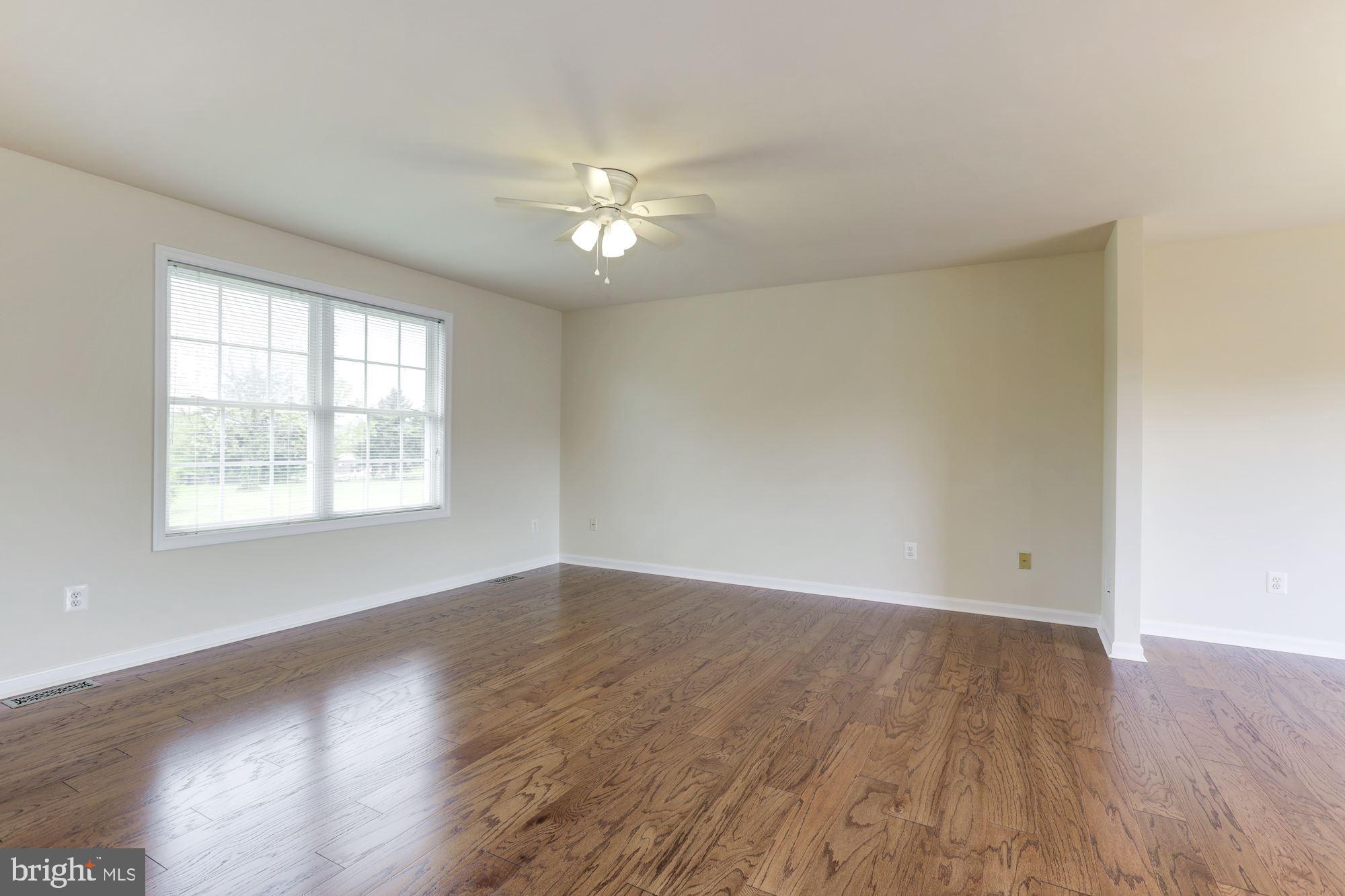 14065 Micah Road Rixeyville, VA 22737 - Photo 7 of 40 an empty room with wooden floor and windows