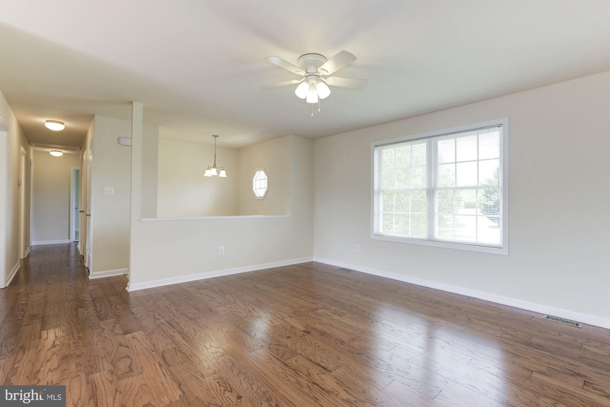 14065 Micah Road Rixeyville, VA 22737 - Photo 8 of 40 a view of an empty room with wooden floor and a window