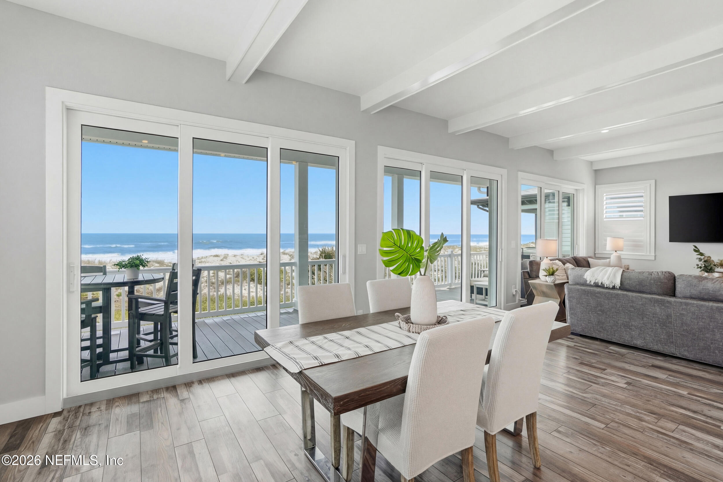 1717 Strand Street Neptune Beach, FL 32266 - Photo 13 of 84 a living room with furniture a large window and wooden floor