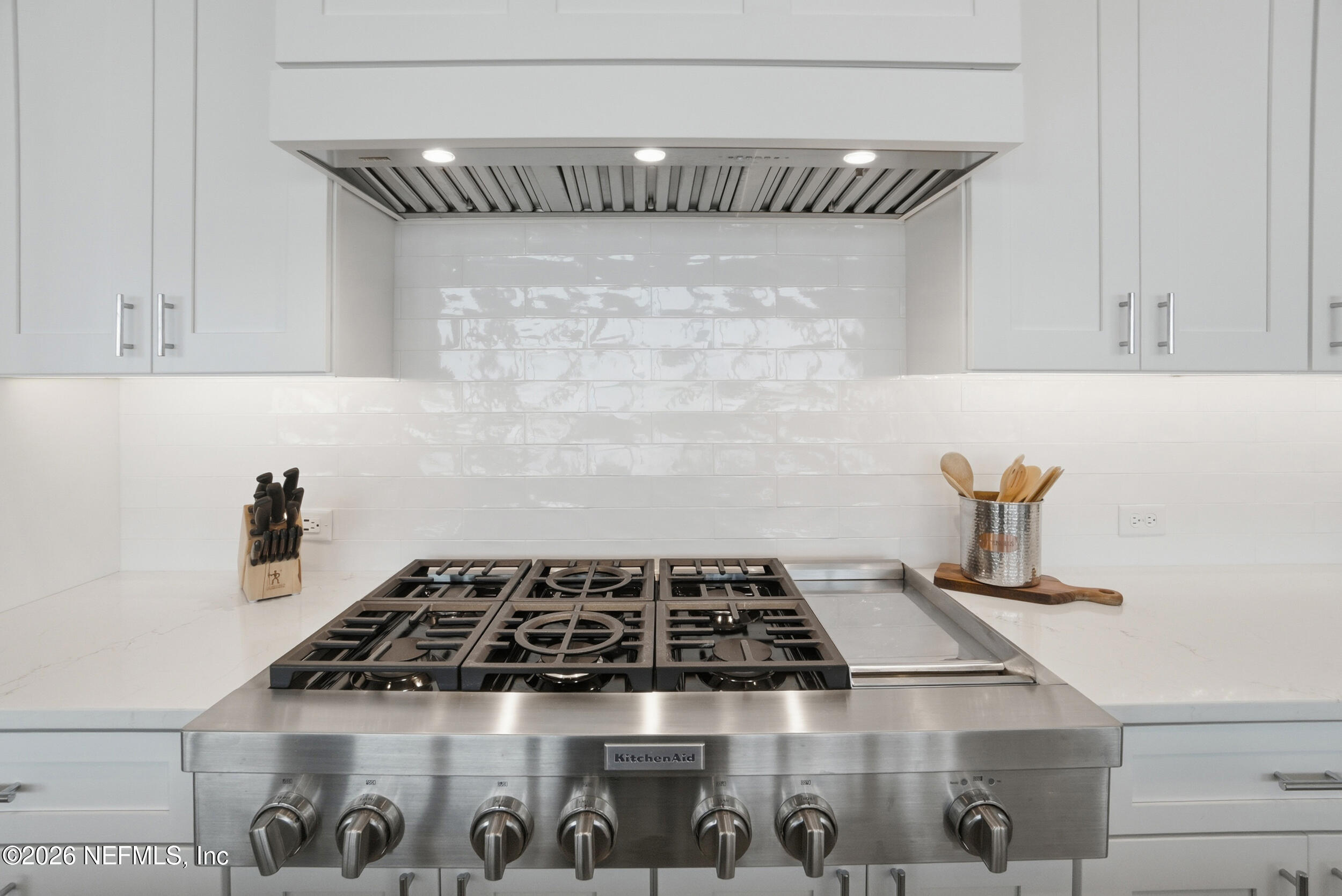 1717 Strand Street Neptune Beach, FL 32266 - Photo 18 of 84 a close view of a stove a microwave and cabinets in a kitchen