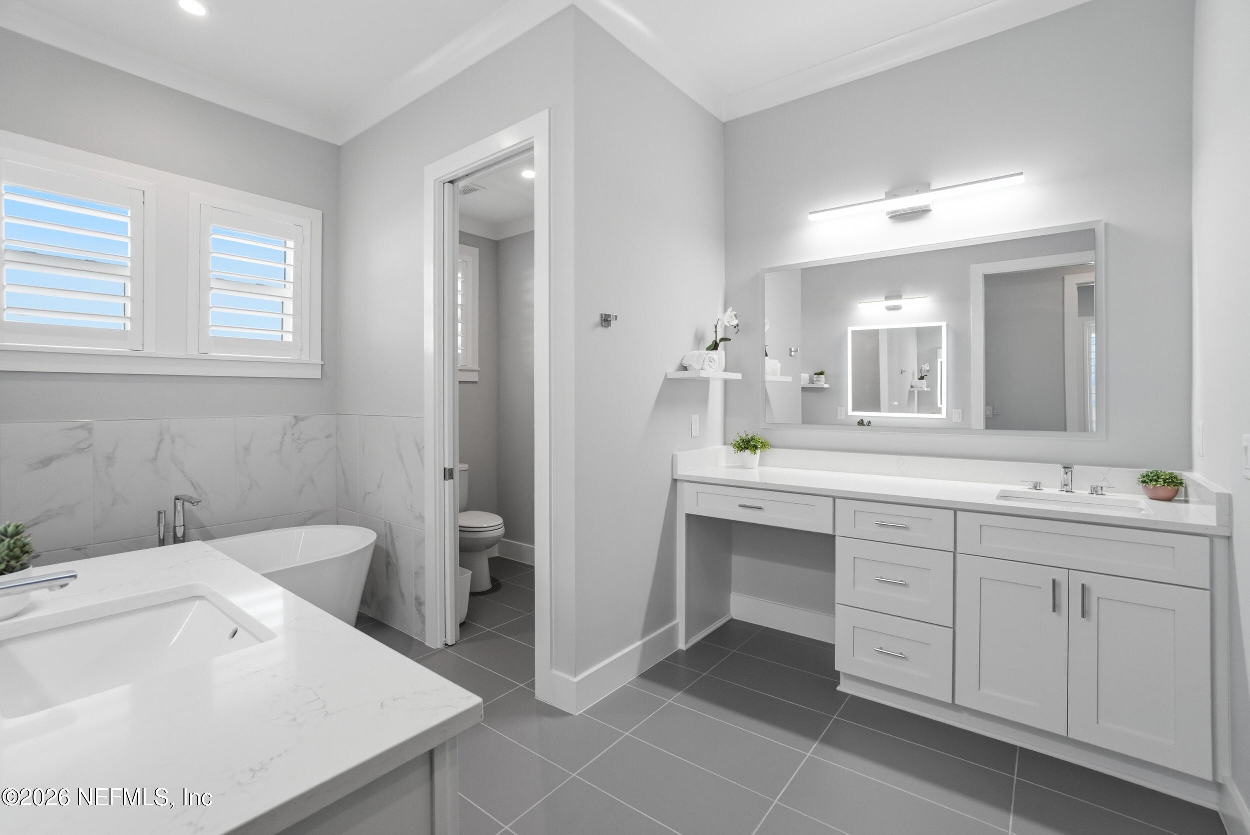 1717 Strand Street Neptune Beach, FL 32266 - Photo 25 of 84 a spacious bathroom with a bathtub sink and mirror