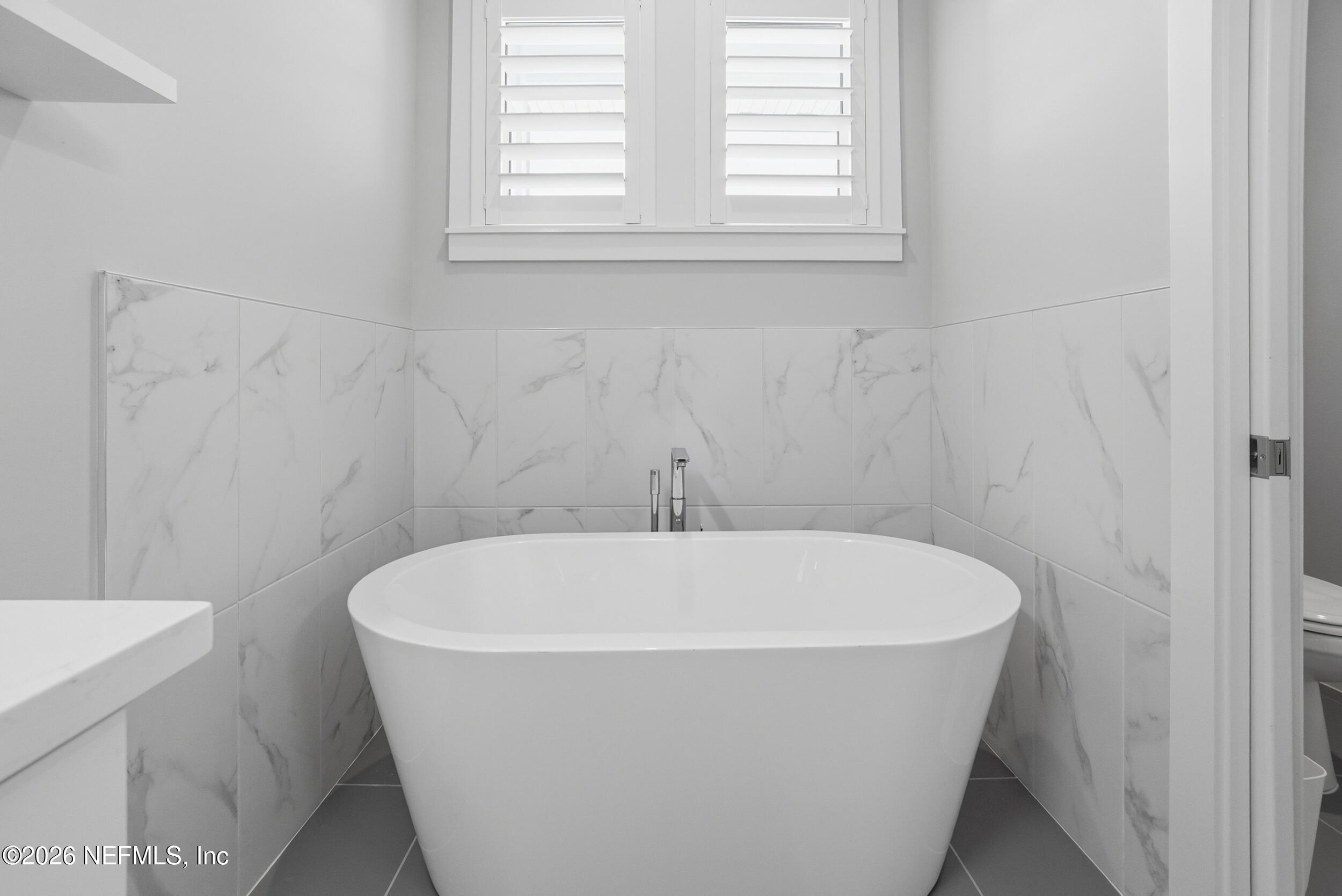 1717 Strand Street Neptune Beach, FL 32266 - Photo 27 of 84 a white bath tub sitting in a bathroom