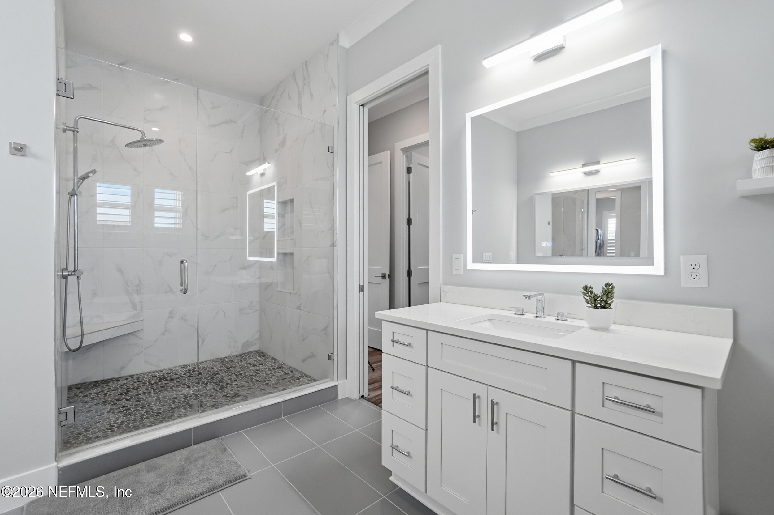 1717 Strand Street Neptune Beach, FL 32266 - Photo 29 of 84 a spacious bathroom with a shower sink and mirror