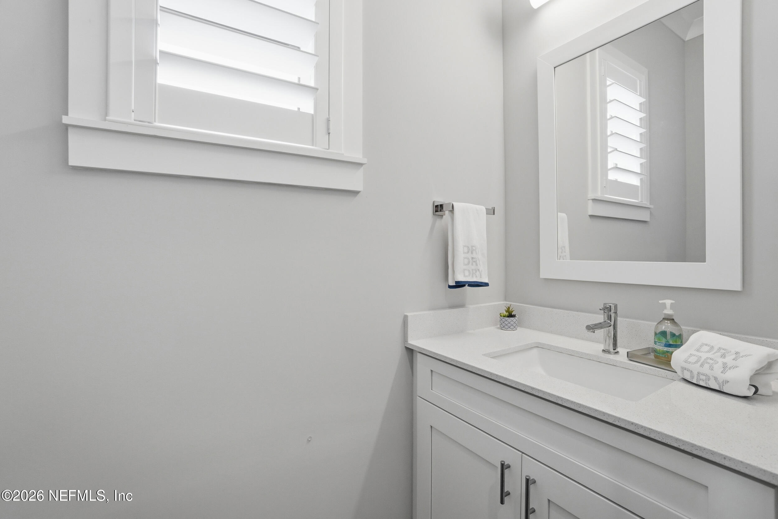 1717 Strand Street Neptune Beach, FL 32266 - Photo 34 of 84 a bathroom with a sink and a mirror