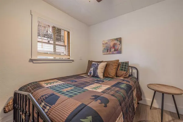 a bed sitting in a bedroom next to a window
