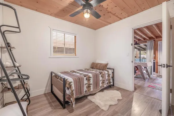 a bedroom with a bed and a chandelier