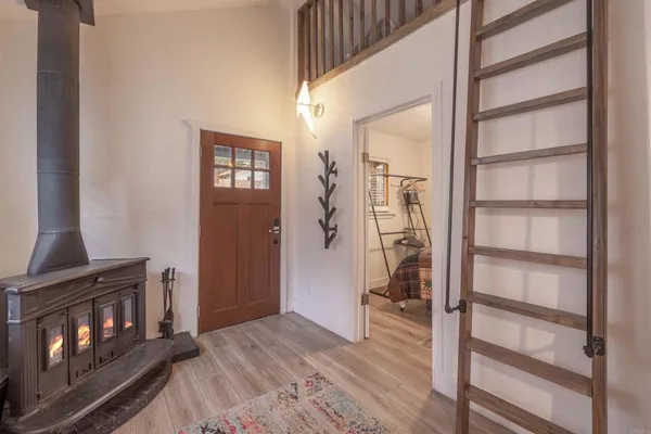 a view of a hallway with wooden floor and staircase