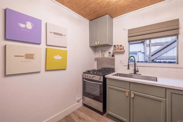 a kitchen with a sink stove and cabinets