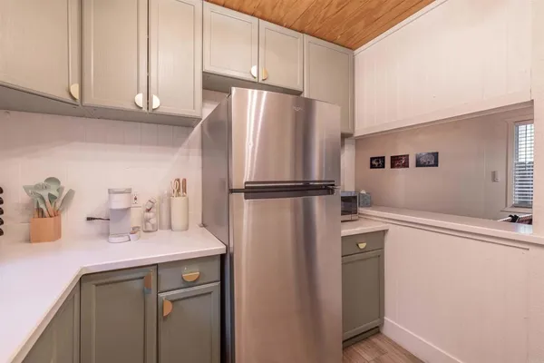 a kitchen with stainless steel appliances a refrigerator sink and cabinets