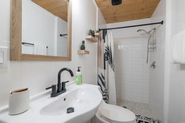 a bathroom with a sink toilet and shower