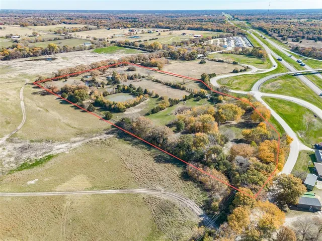 an aerial view of a house with a yard and lake view