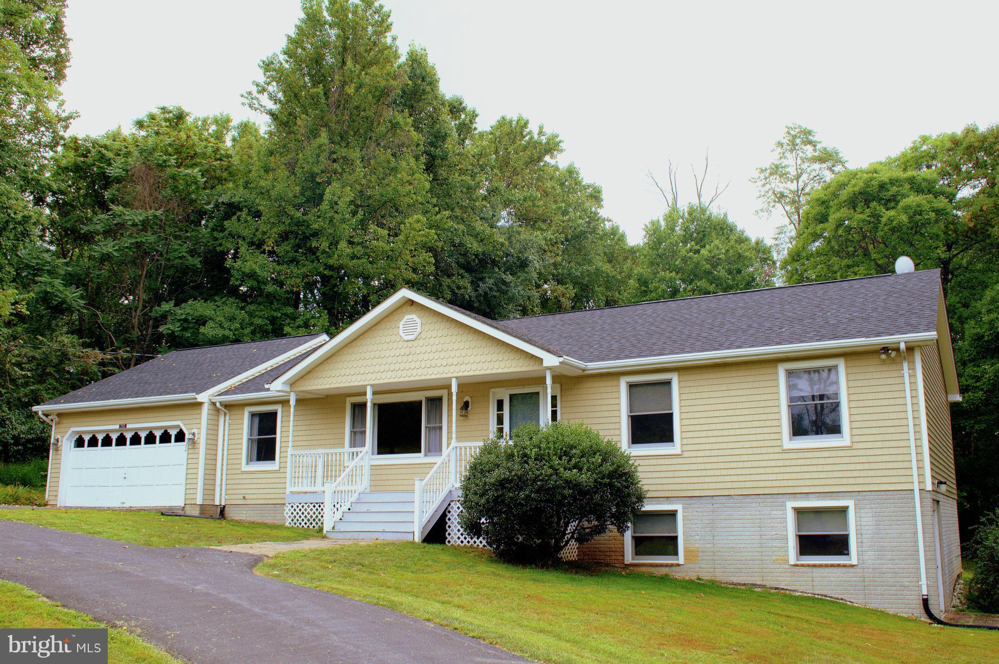 a front view of house with yard and green space