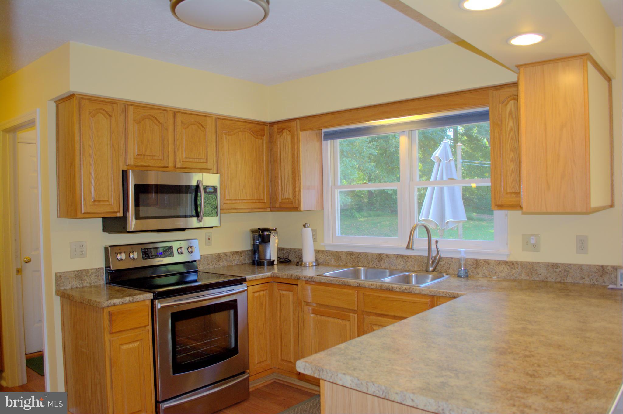 310 High Knob Road Front Royal, VA 22630 - Photo 9 of 30 a kitchen with stainless steel appliances a stove sink and microwave
