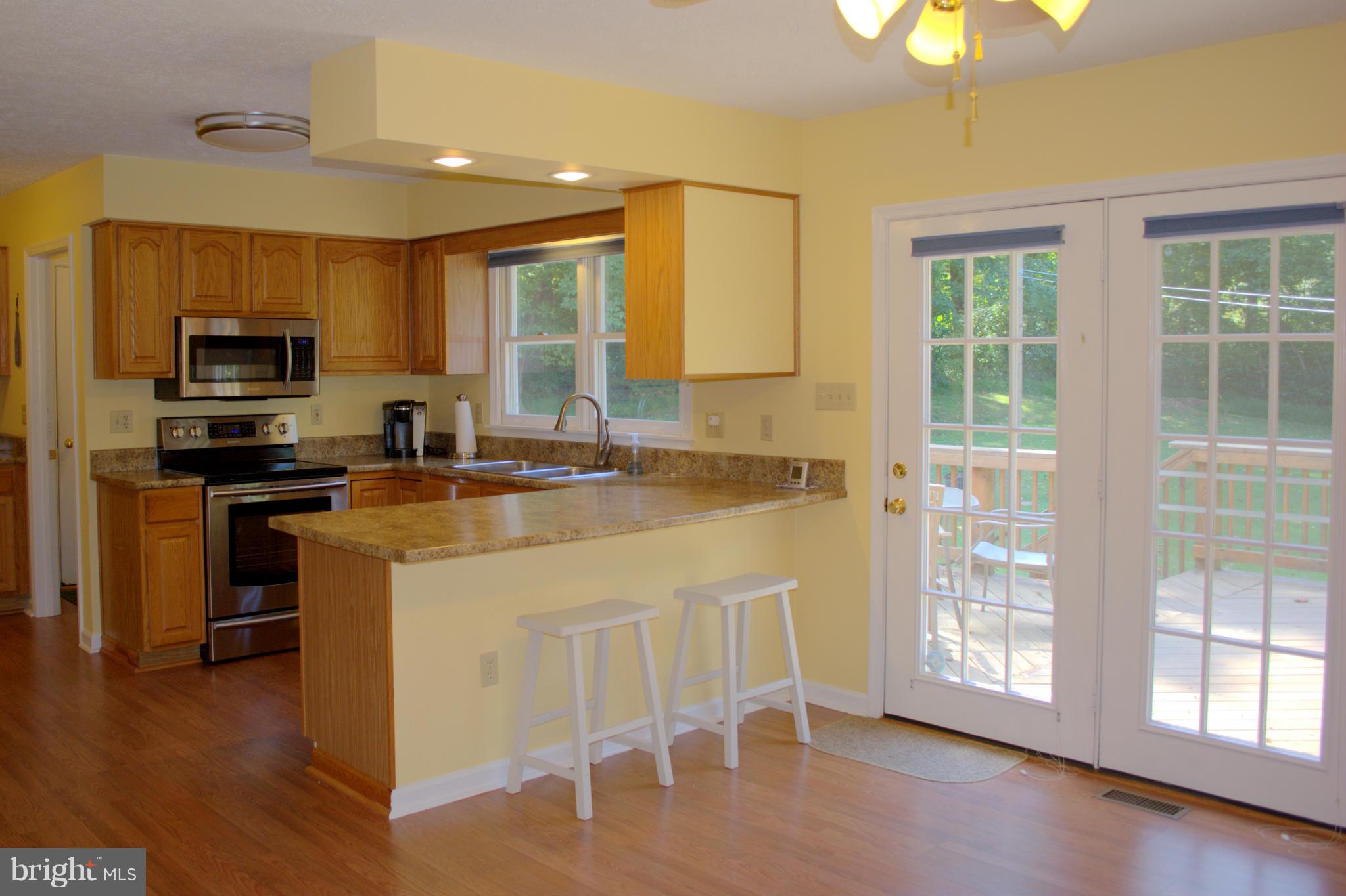 310 High Knob Road Front Royal, VA 22630 - Photo 10 of 30 a kitchen with stainless steel appliances granite countertop a stove a sink a microwave and a refrigerator