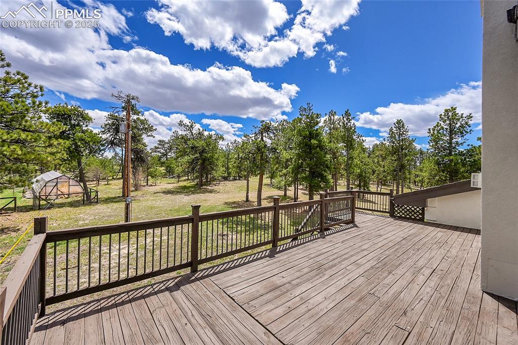 17350 Goshawk Road Colorado Springs, CO 80908 - Photo 17 of 50 a view of a balcony with wooden floor and outdoor space