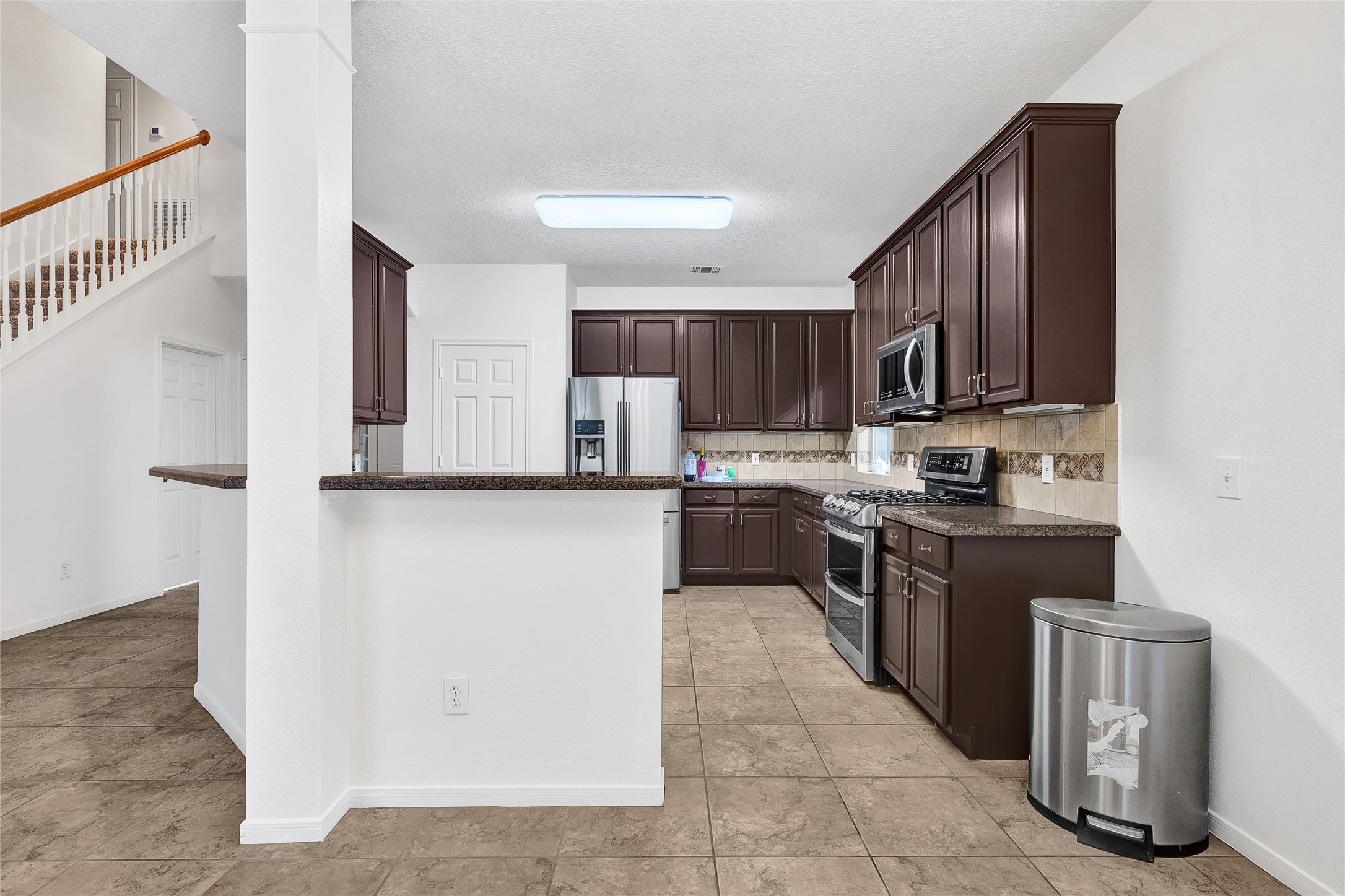 9606 Summer Run Houston, TX 77064 - Photo 14 of 41 Open kitchen design with breakfast bar seating and seamless connection to living areas ideal for everyday living and entertaining.