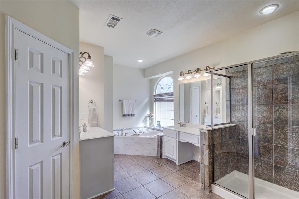 10414 Broadmoor Lane Rowlett, TX 75089 - Photo 17 of 38 Full bath with vanity, a stall shower, light tile patterned floors, and a garden tub