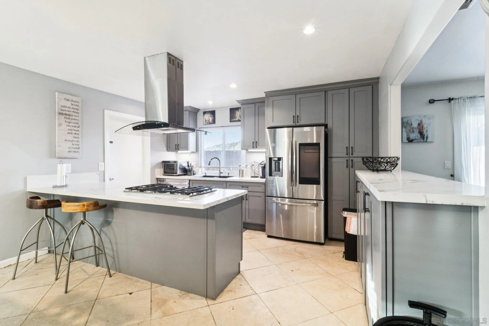 3365 South Bonita Street Spring Valley, CA 91977 - Photo 16 of 32 a kitchen with refrigerator and chairs