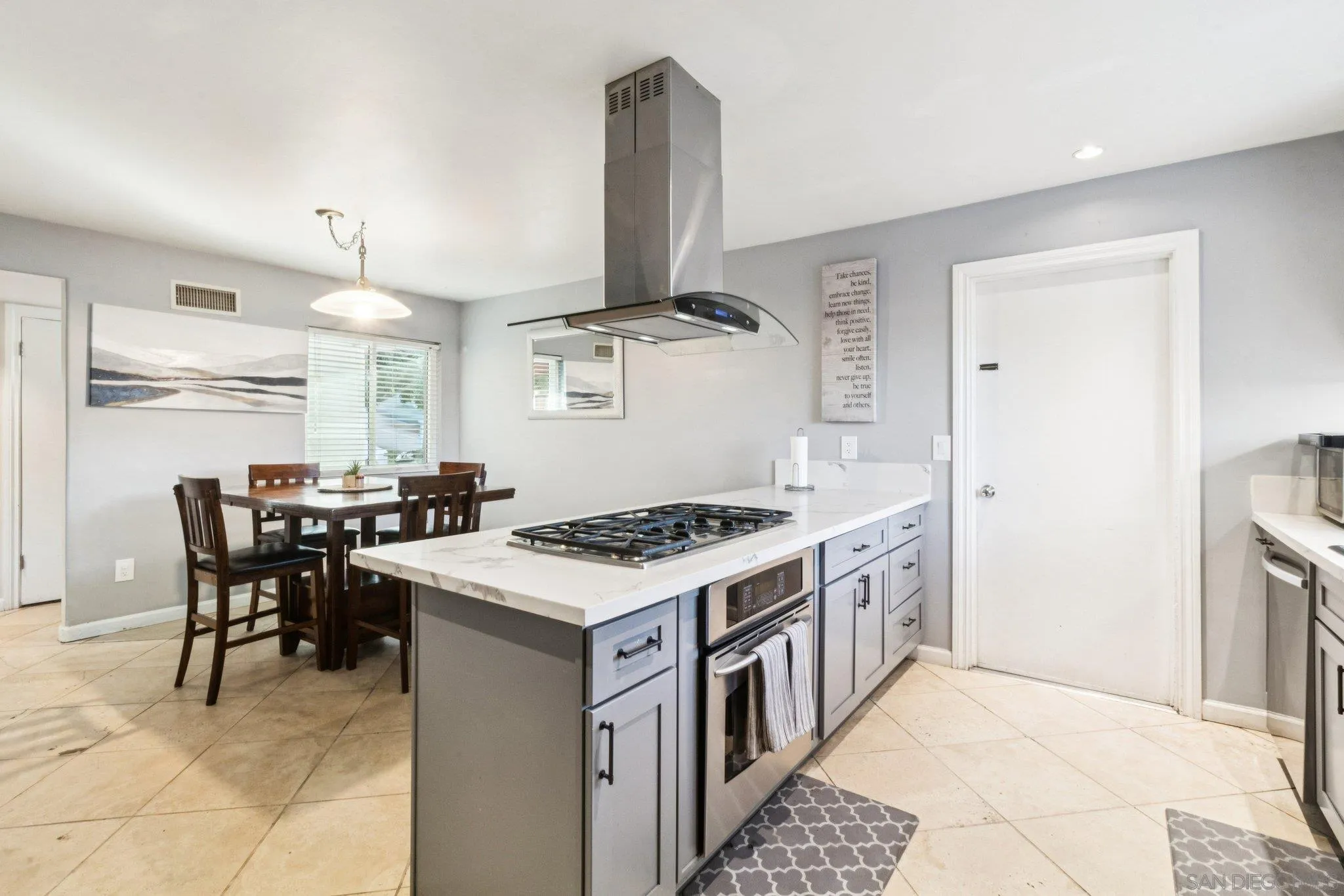 3365 South Bonita Street Spring Valley, CA 91977 - Photo 18 of 32 a kitchen with a stove a table and chairs