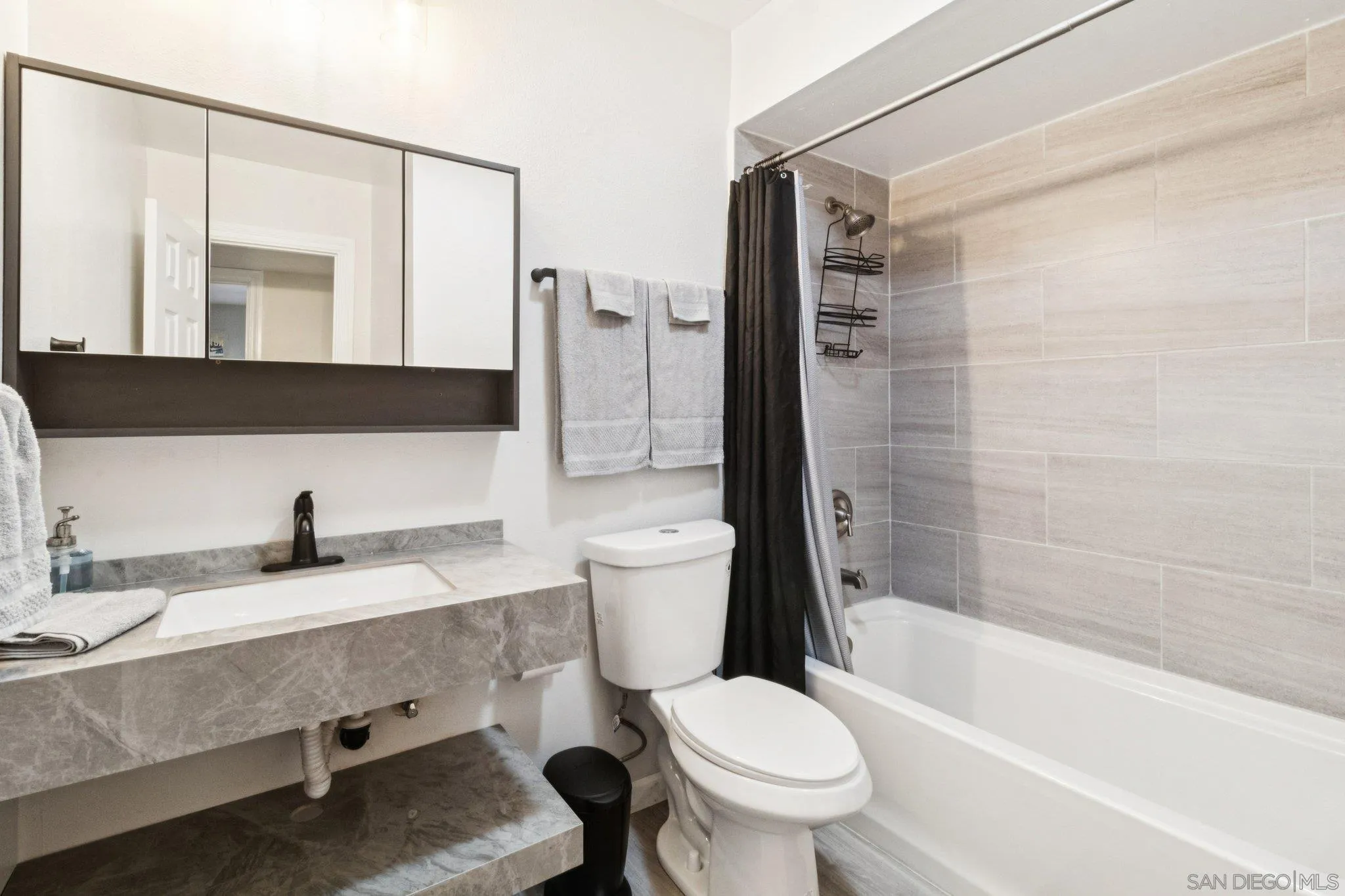 3365 South Bonita Street Spring Valley, CA 91977 - Photo 21 of 32 a bathroom with a granite countertop sink toilet and shower