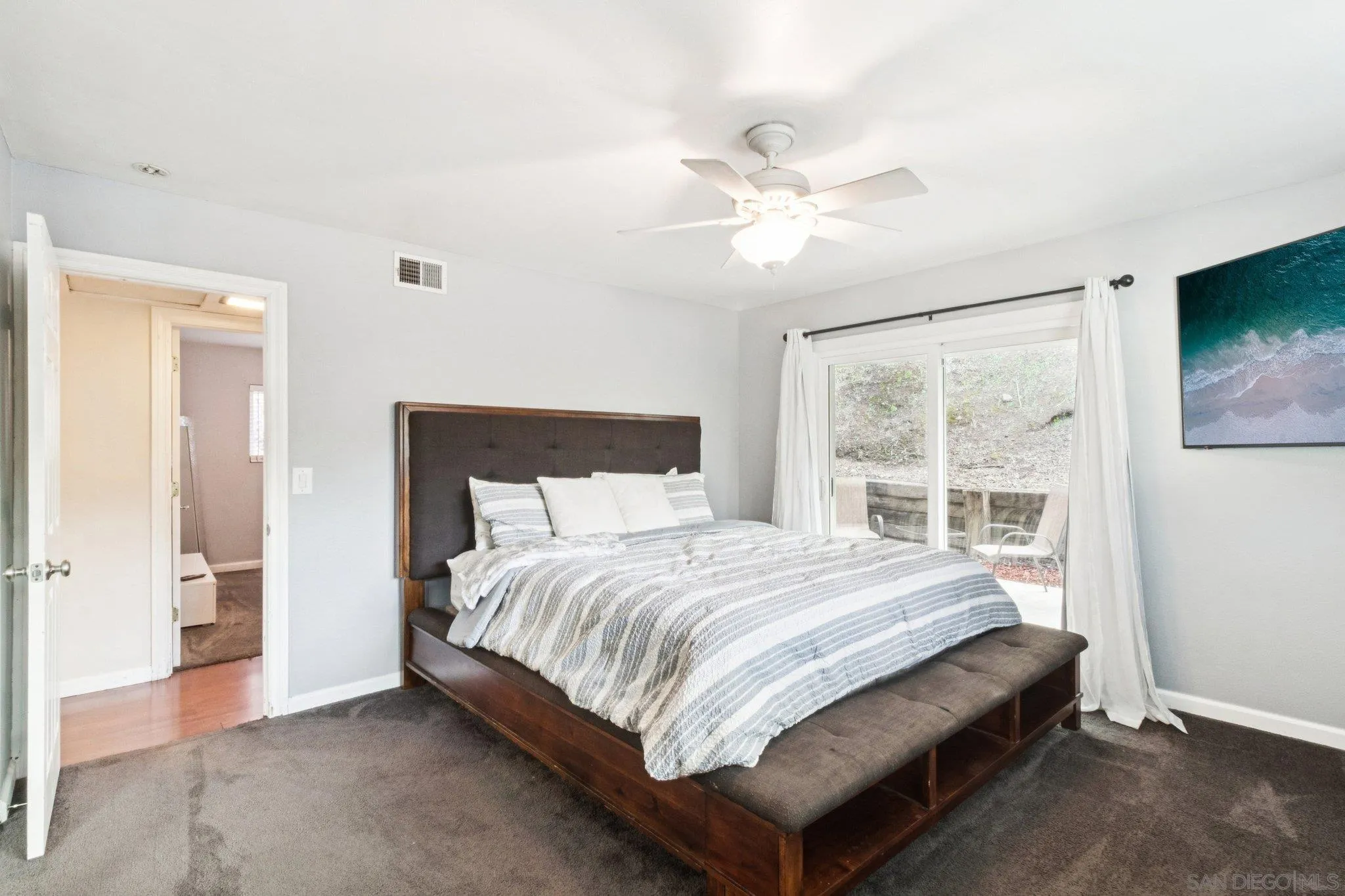 3365 South Bonita Street Spring Valley, CA 91977 - Photo 23 of 32 a bedroom with a bed and a chandelier
