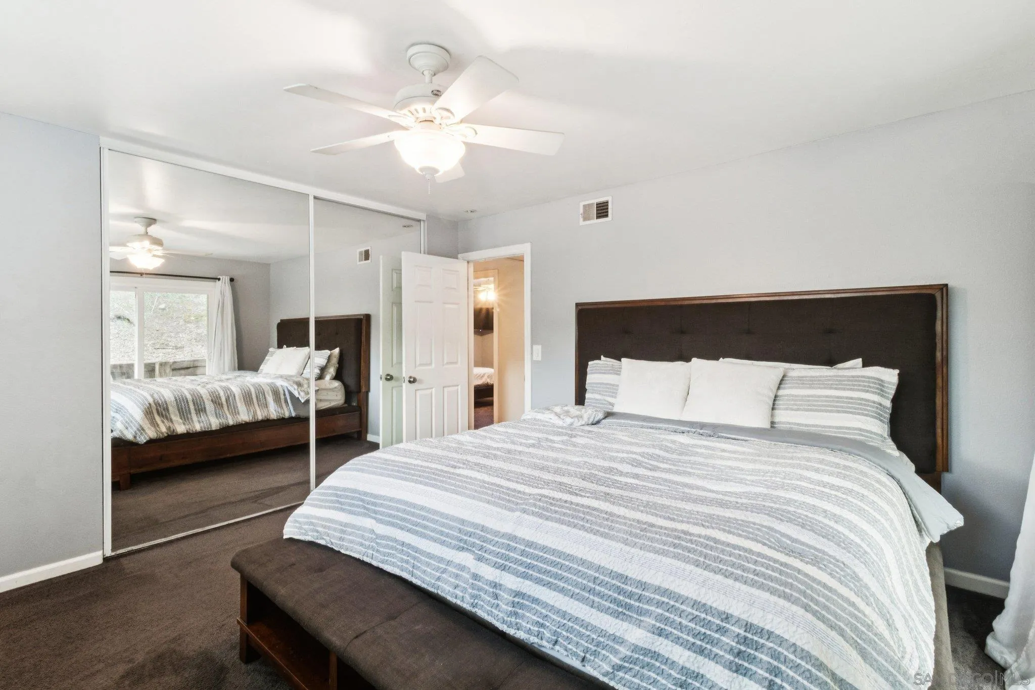 3365 South Bonita Street Spring Valley, CA 91977 - Photo 24 of 32 a bedroom with a bed and a large mirror