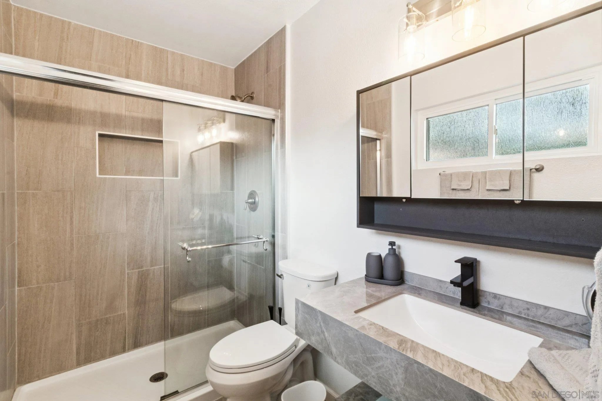 3365 South Bonita Street Spring Valley, CA 91977 - Photo 25 of 32 a bathroom with a granite countertop sink a toilet and shower