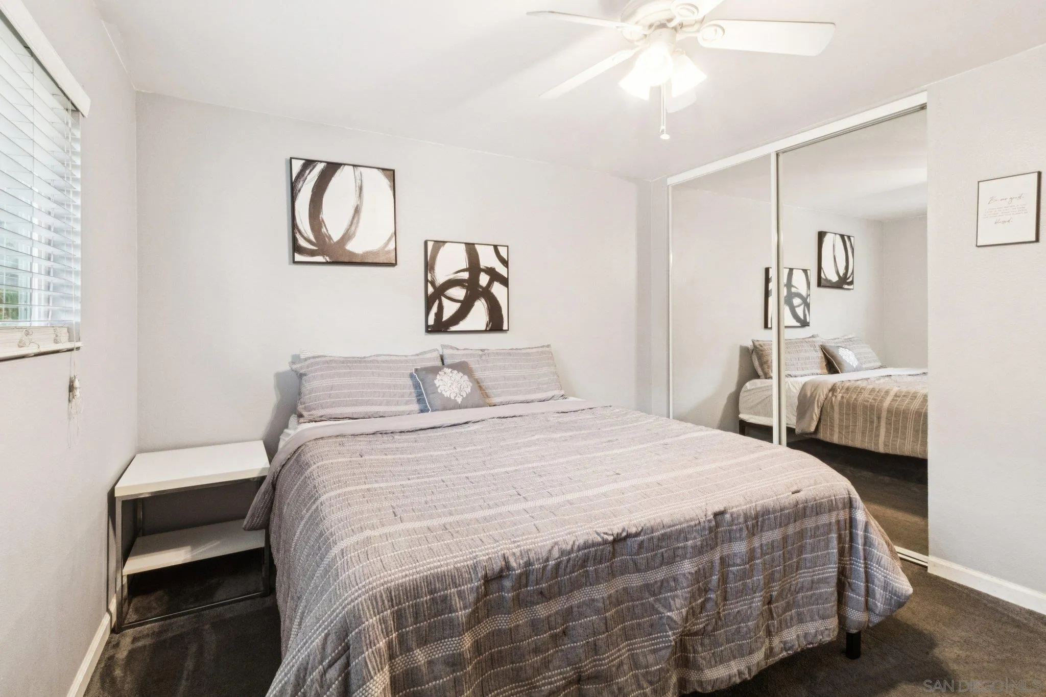 3365 South Bonita Street Spring Valley, CA 91977 - Photo 27 of 32 a bedroom with a bed and a chandelier